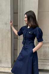 a lady in a denim top and a solid denim dress